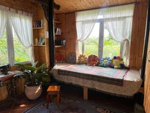 a room with a bed with stuffed animals on it at Homestay Vườn Của Gió in Ấp Thanh Sơn (1)