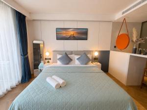a bedroom with a bed with two towels on it at The Sunshine Beach Resort Studio in Layan Beach