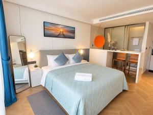 a hotel room with a bed and a mirror at The Sunshine Beach Resort Studio in Layan Beach