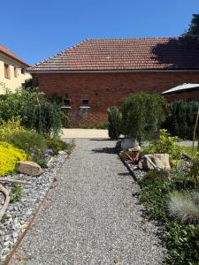 a garden with rocks and a brick building at Ubytování pod Třešní in Telč