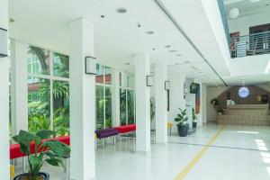an empty lobby of a hospital with plants at Microtel by Wyndham UP Technohub in Manila +36 photos