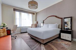 a bedroom with a large white bed and a desk at Park South Hotel, part of JdV by Hyatt in New York +26 photos
