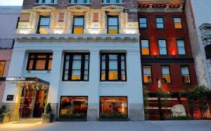 a large white building with windows on a city street at Park South Hotel, part of JdV by Hyatt in New York
