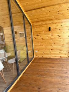 a wood paneled room with a table and chairs at Барнхаус in Cholpon-Ata