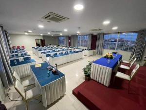 a conference room with blue tables and chairs at Khemra Guesthouse in Kampot in Kampot