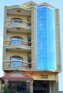 a tall building with a blue glass building at Khemra Guesthouse in Kampot in Kampot
