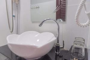 a bathroom sink with a heart shaped sink at Khemra Guesthouse in Kampot in Kampot +11 photos