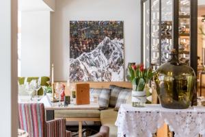 a living room with a table and a couch at Ski Hotel Mondschein 1739 in Stuben am Arlberg +41 photos