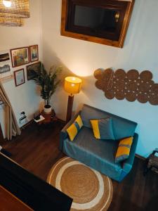 a living room with a couch and a tv at Casa Arrayan in Coñaripe