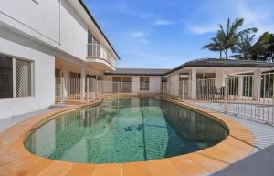 a swimming pool in the middle of a house at Stunning Waterfront Escape in Gold Coast