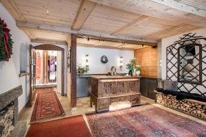 a living room with wooden ceilings and a wooden table at Ski Hotel Mondschein 1739 in Stuben am Arlberg