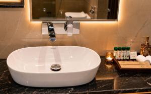a white sink in a bathroom with a mirror at Kaya Nature Resort in Ajabgarh +23 photos