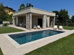 a swimming pool in front of a house at Villa Grace in Padenghe sul Garda
