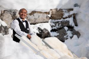 a man is standing in the snow with skis at Ski Hotel Mondschein 1739 in Stuben am Arlberg