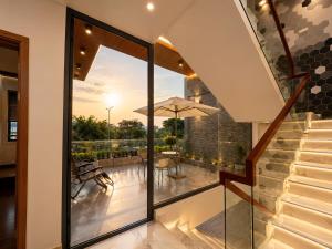 a house with a view of a balcony with glass doors at Hoàng Vũ VILLA in Nhâm Lăng