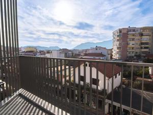a balcony with a view of a city at Enjoy Shkodra Apartment in Shkodër