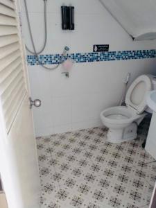 a bathroom with a white toilet and a sink at Pineapple Express hostel at BKK in Bang Bua Thong Railway Station