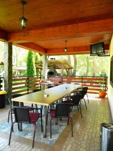 a large table and chairs on a patio at Alpenhaus in Voineasa
