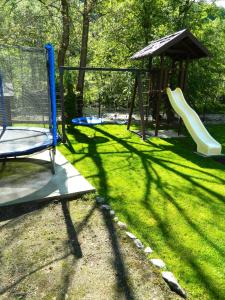 a playground with a slide and a play structure at Alpenhaus in Voineasa