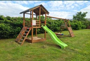 a playground with a slide and a climbing frame at Domki U Grega na kaszubach in Wiele