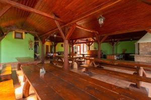 a large room with wooden benches in a building at Hotel Velky Meder in Veľký Meder