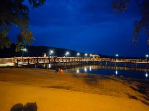 a bridge over a body of water at night at Domki U Grega na kaszubach in Wiele +1 photo