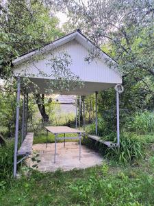 a picnic shelter with a table and a bench at Avaxil Pirqulu in Avaxıl +5 photos