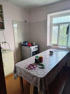 a kitchen with a table with a table cloth on it at Avaxil Pirqulu in Avaxıl