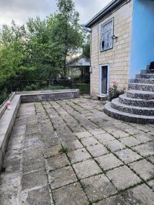 a stone patio with stairs and a building at Avaxil Pirqulu in Avaxıl