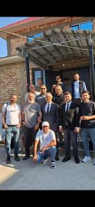 a group of men in suits and ties posing for a picture at Guest house USMAN in Kazarman