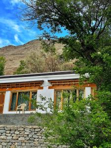 a house with a chair in front of it at Lharje Resort in Satti