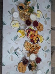 a table topped with lots of different types of food at Guest house USMAN in Kazarman