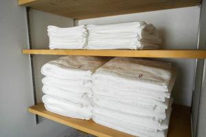 a bunch of towels are stacked on a shelf at Nagano Villa 翠 in Nagano +42 photos