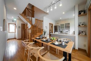 a kitchen and dining room with a table and chairs at Nagano Villa 翠 in Nagano