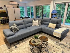 a living room with a gray couch and a table at Le RuissO - Spa et Confort in Brownsburg +63 photos