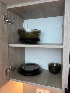 a cabinet with plates and a bowl in it at MOuntain View Apartment in Câmpulung