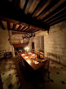 a dining room with a long wooden table and chairs at Donjon de Saintines - gîte 6 adultes 3 enfants - monument historique in Saintines