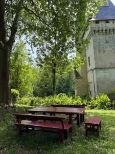 a picnic table and bench in front of a building at Donjon de Saintines - gîte 6 adultes 3 enfants - monument historique in Saintines