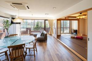 a living room with a table and a couch at Mitte Misono Apartments in Sapporo