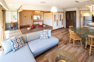a living room with a couch and a table at Mitte Misono Apartments in Sapporo +44 photos