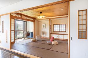 a living room with a large open door at Mitte Misono Apartments in Sapporo