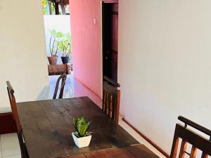 a dining room with a table with a plant on it at Lakeside Haven Resort in Habarana