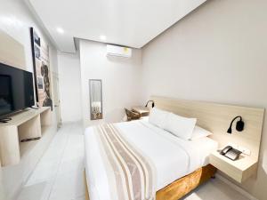 a bedroom with a large bed and a television at Casa Helena Hotel Centro Historico in Cartagena de Indias +110 photos