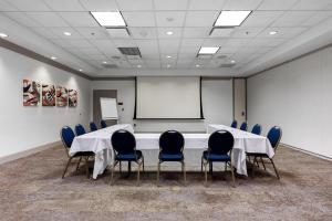 a conference room with a table and chairs and a whiteboard at Hilton Garden Inn Ithaca in Ithaca +30 photos