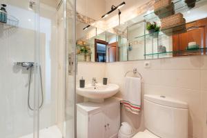 a bathroom with a sink and a toilet and a shower at IZURRENEA Casa Rural in Arano +36 photos
