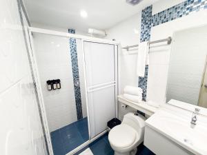 a bathroom with a toilet and a shower at Casa Helena Hotel Centro Historico in Cartagena de Indias