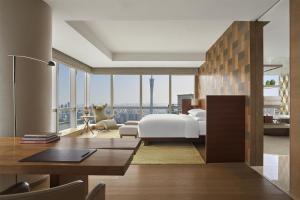 a hotel room with a bed and a desk and a bedroom at Park Hyatt Guangzhou in Guangzhou +134 photos