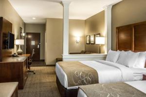 a hotel room with two beds and a television at Comfort Suites Hartville-North Canton in Uniontown