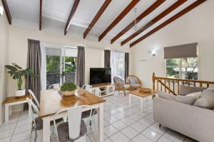 a living room with a couch and a table at Comfort Resort Blue Pacific in Mackay