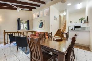 a dining room and living room with a table and chairs at Comfort Resort Blue Pacific in Mackay